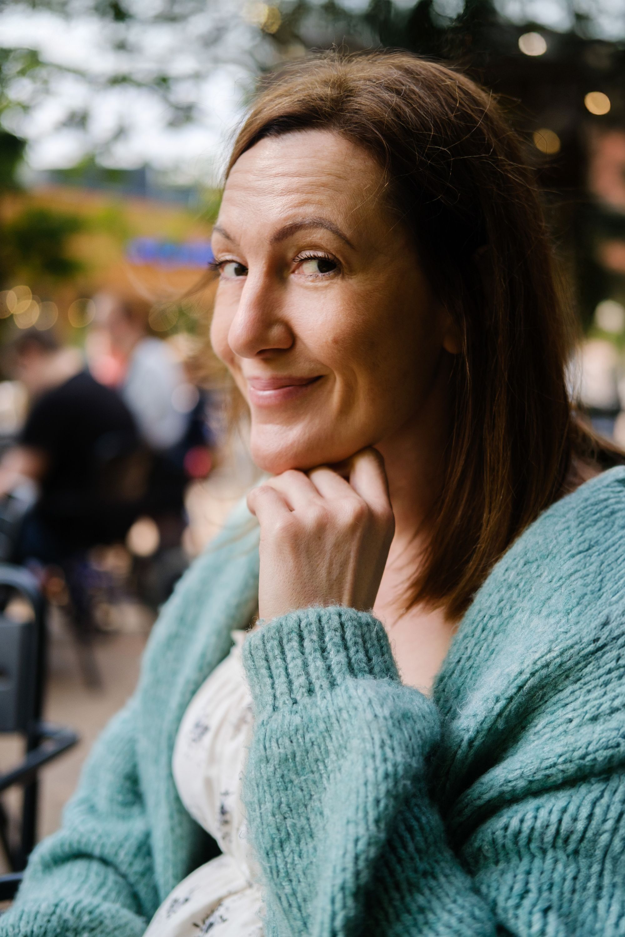 Rachel smiling outdoors in a soft blue jumper
