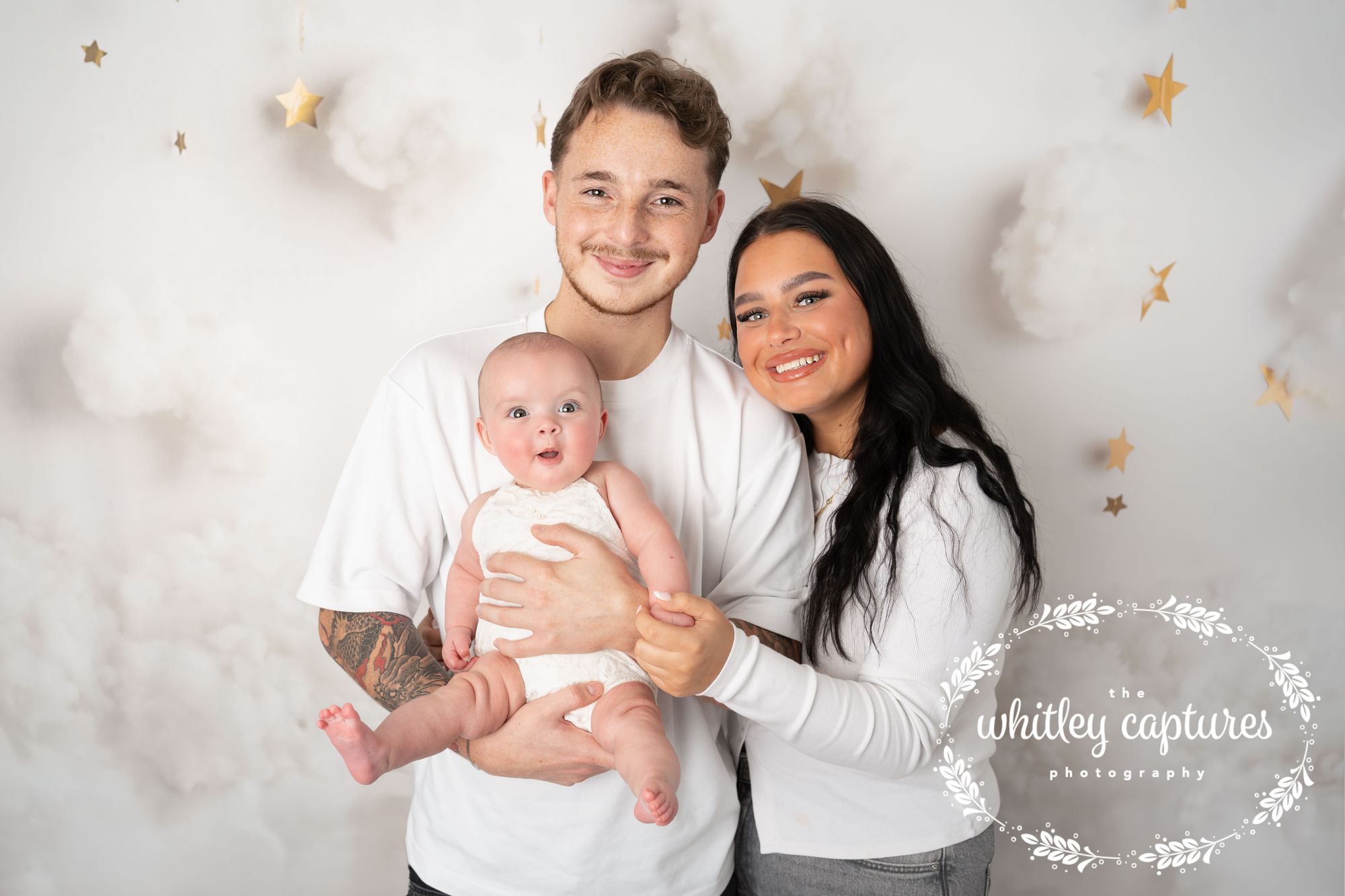 Parents holding their newborn together