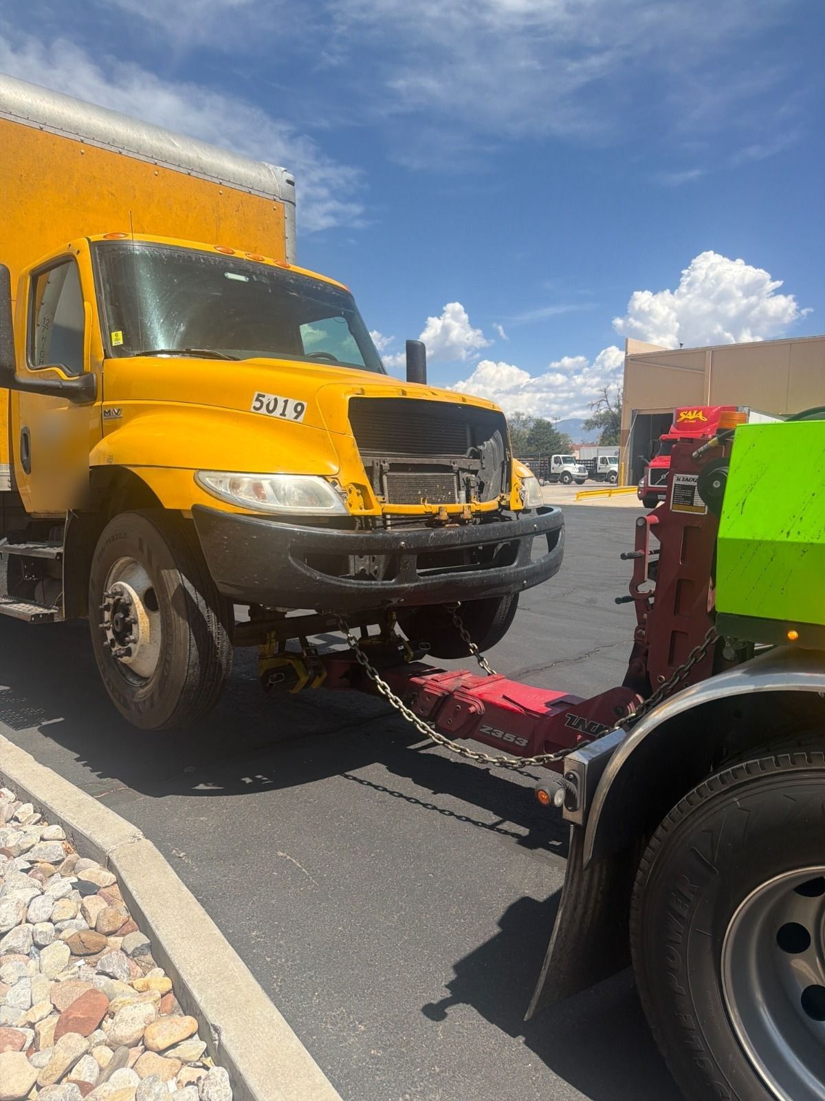 Damaged box truck lifted on a NOVA wrecker underlift after an accident