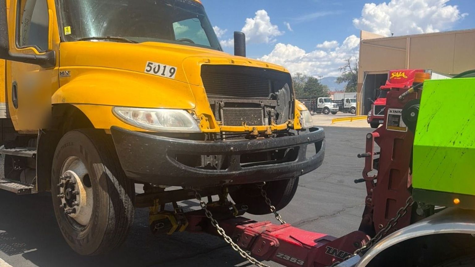 Damaged box truck lifted on a NOVA wrecker underlift after an accident