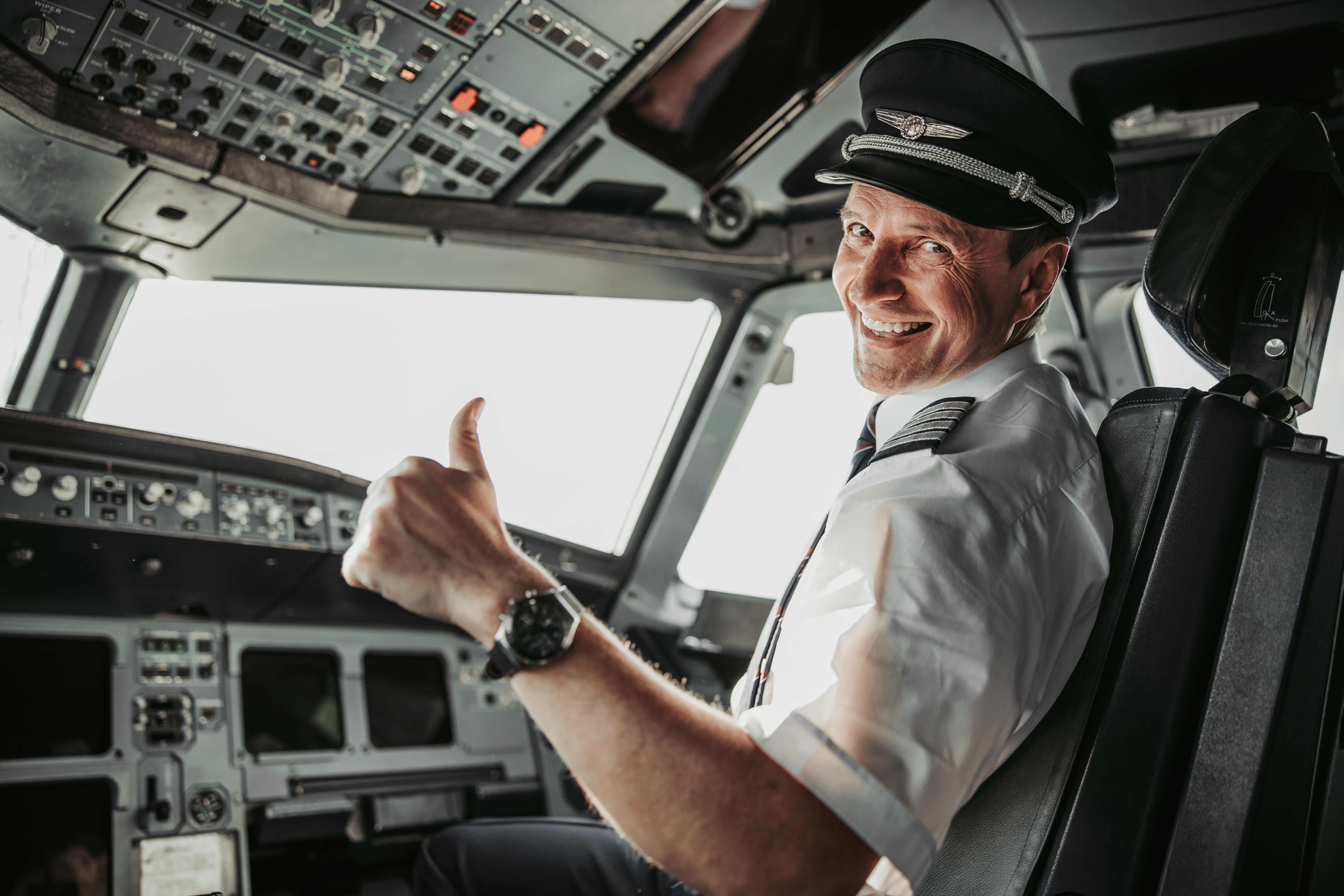 An airline captain in the cockpit giving a thumbs-up — illustrative, not the individual named in the case.