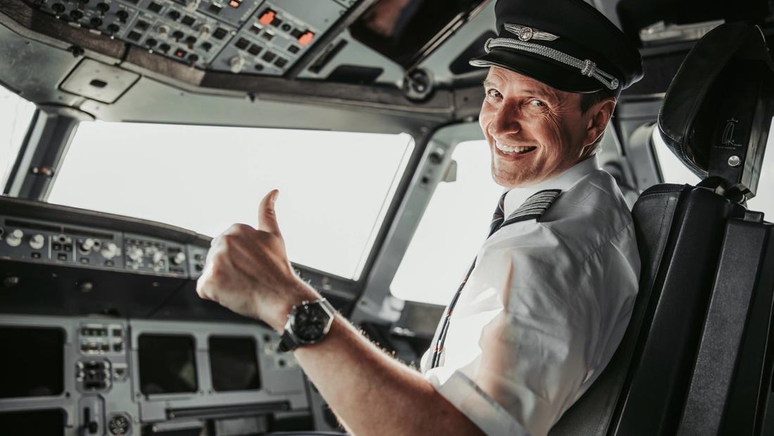 An airline captain in the cockpit giving a thumbs-up — illustrative, not the individual named in the case.
