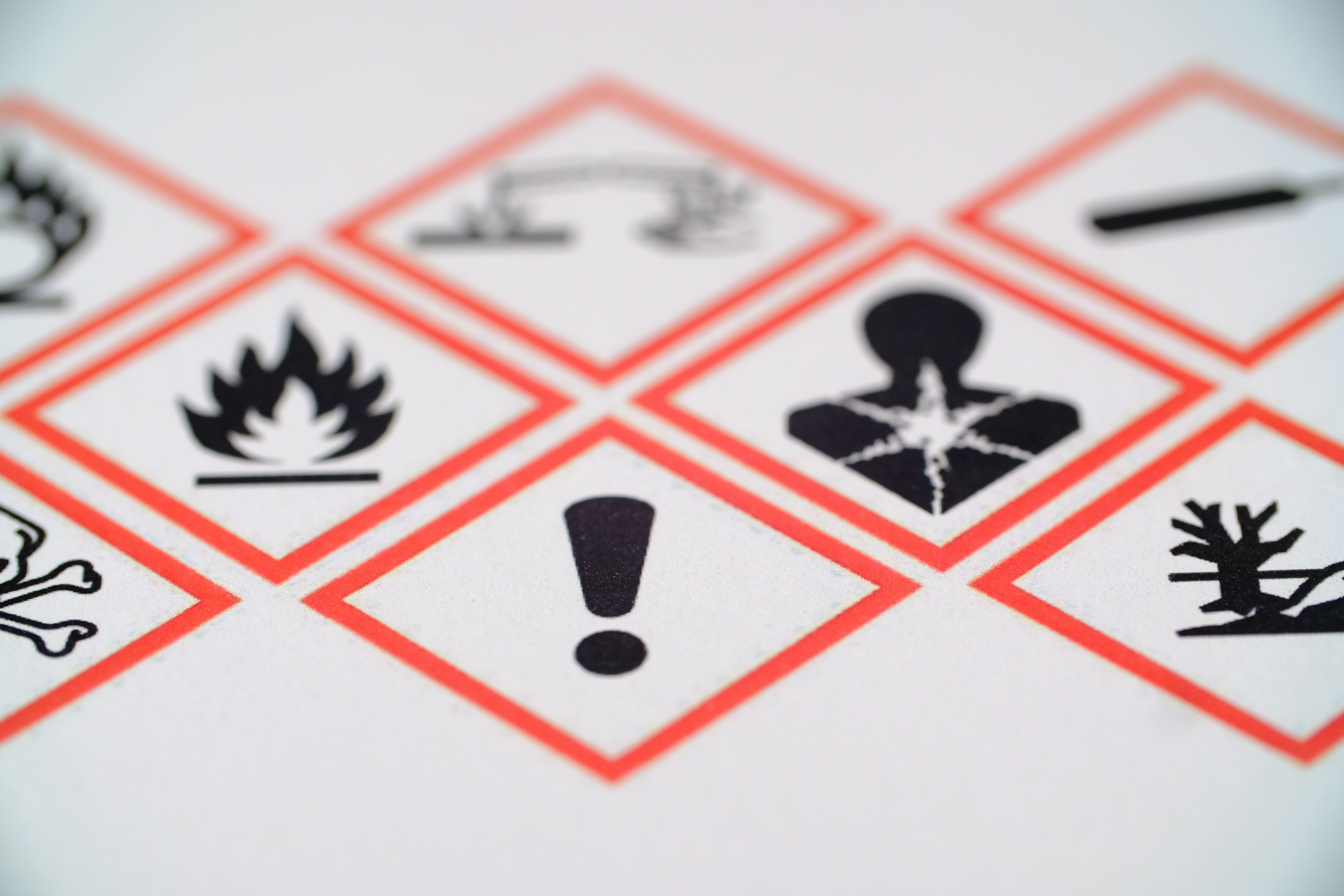 WHMIS GHS hazard pictograms — red diamond warning symbols including flammable, health hazard, and exclamation mark labels