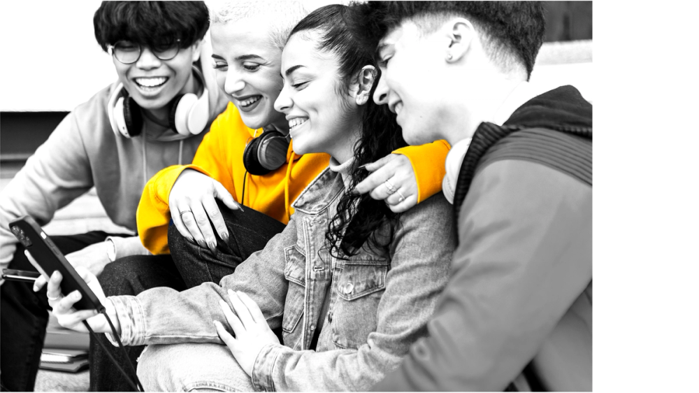 Teenagers hugging while watching a phone Teenagers hugging while watching a phone