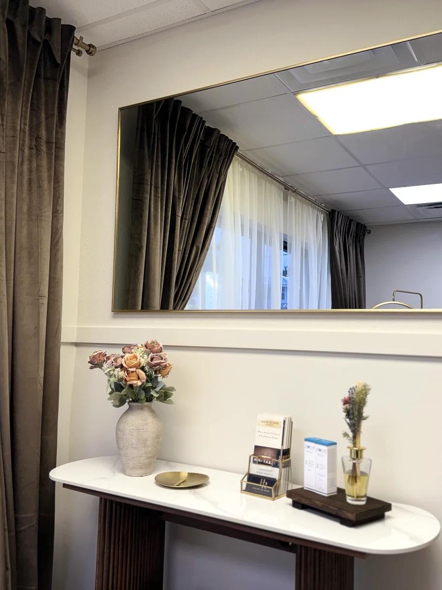 Gold-framed mirror and console styling area at House of Rose
