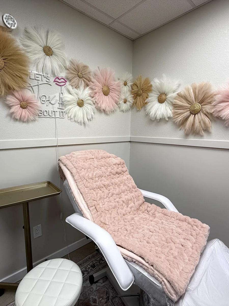 Injectables treatment room at House of Rose with floral wall and treatment chair