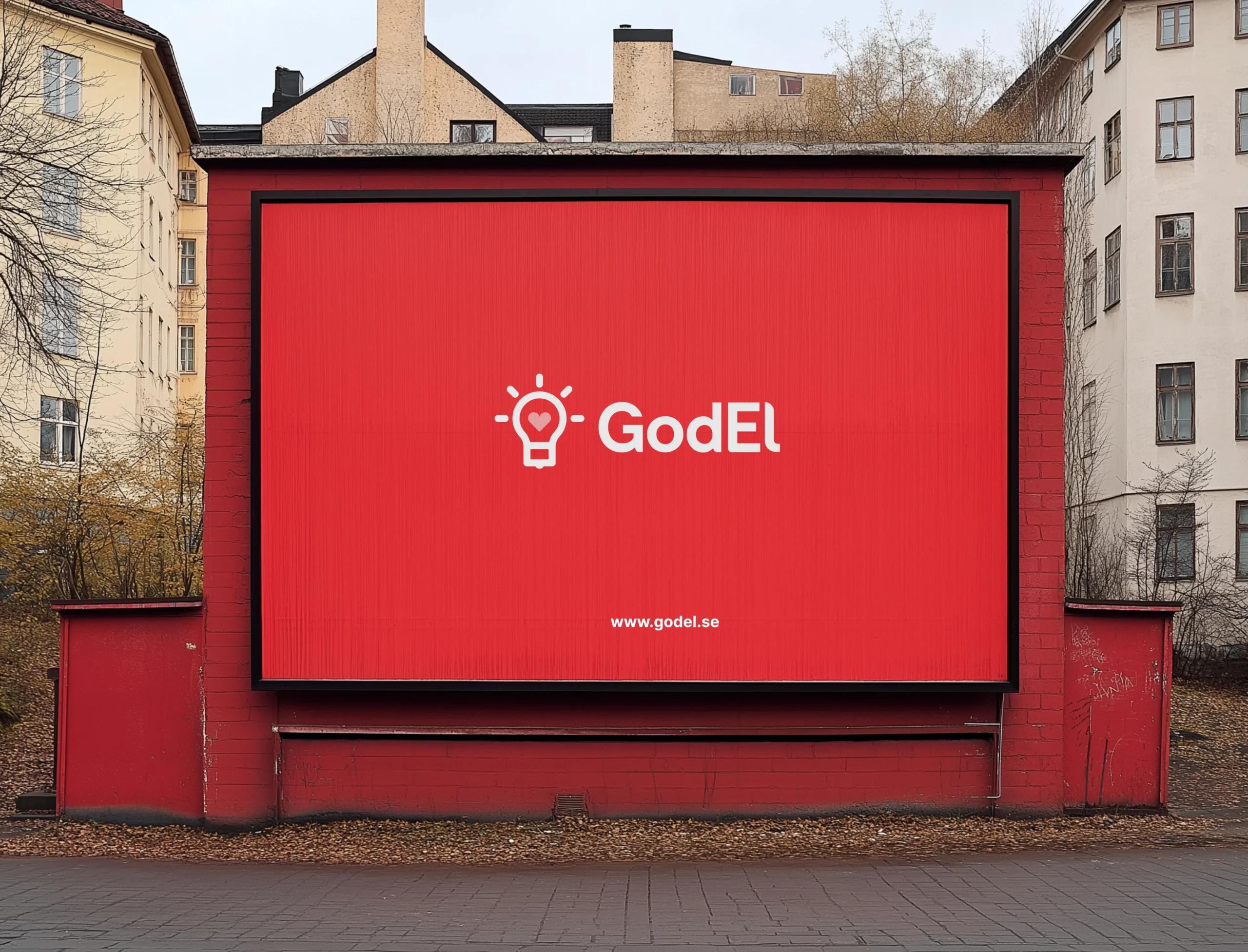 GodEl logo on a red billboard with a light bulb icon and website link in an urban setting.