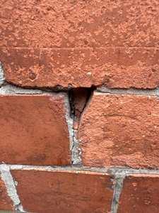Frost-damaged brickwork and open mortar joints