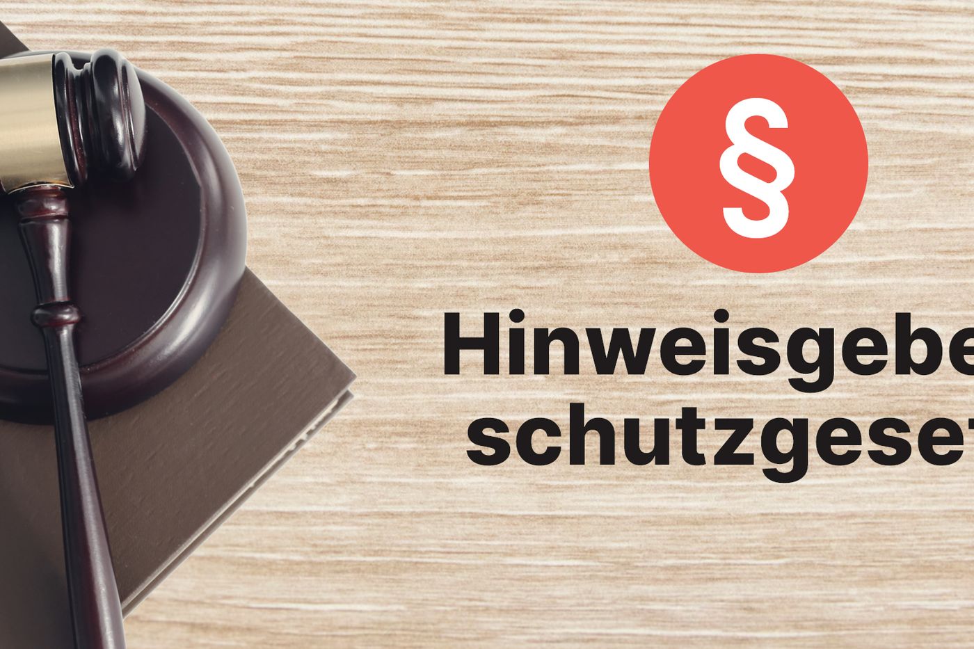 Richterhammer auf einem Gesetzbuch neben Paragrafenzeichen und Schriftzug Hinweisgeberschutzgesetz