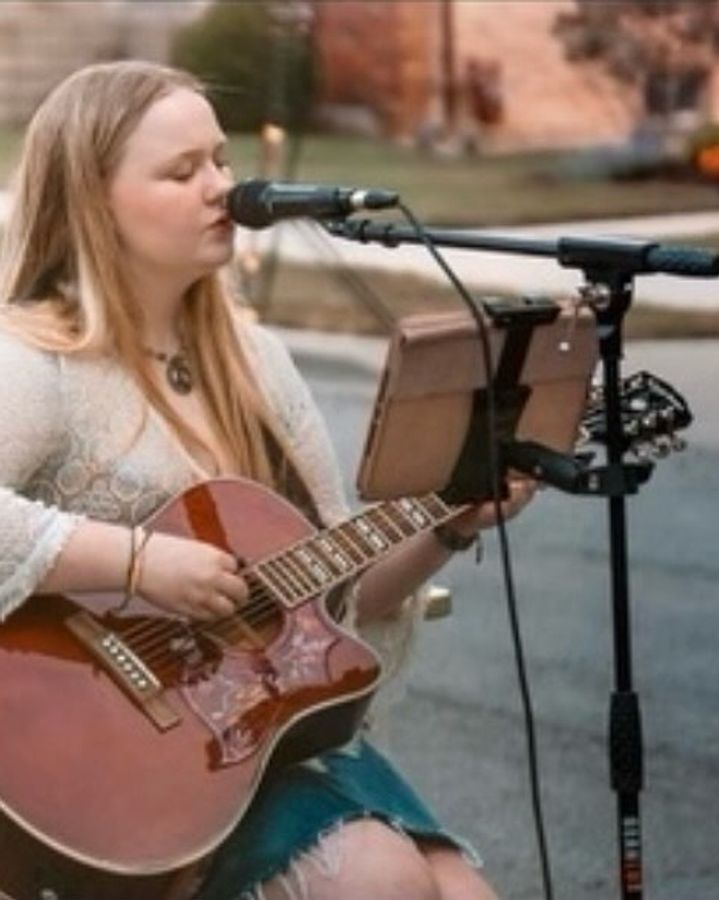 Acoustic singer performing outdoors on the Porter Cullens patio