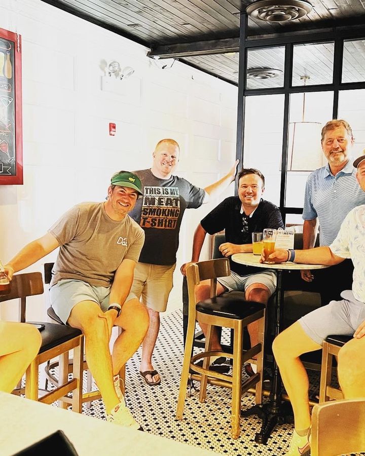 Friends gathered on bar stools in the private event room