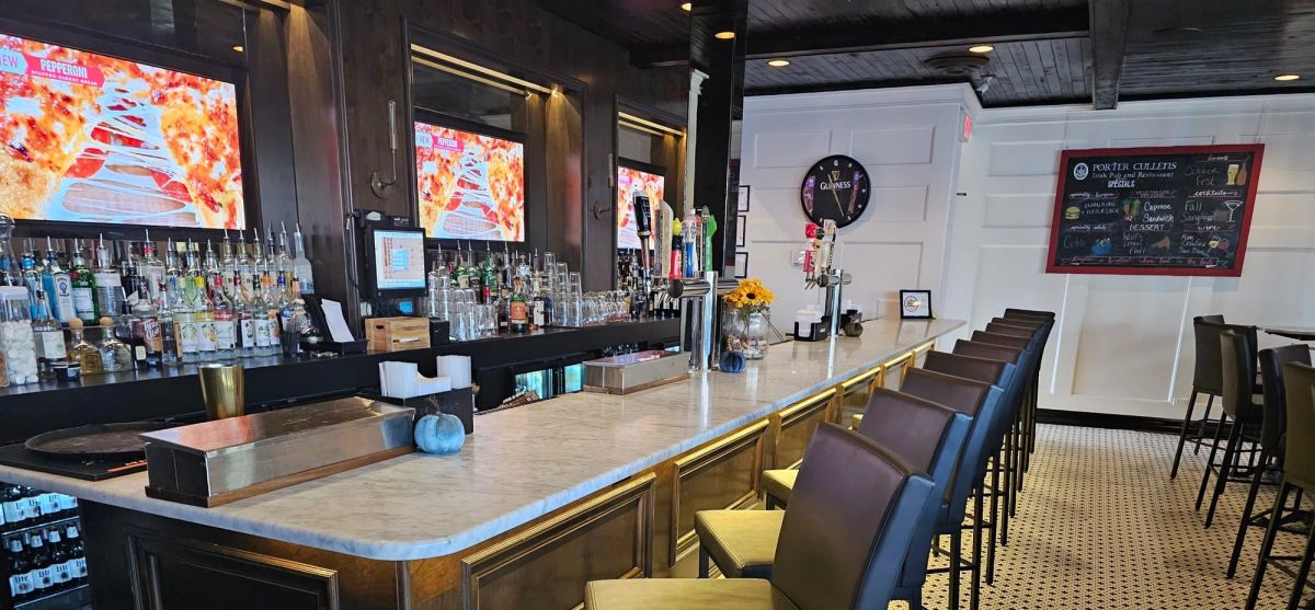 The main bar at Porter Cullens with marble counter, tap row and bar seating