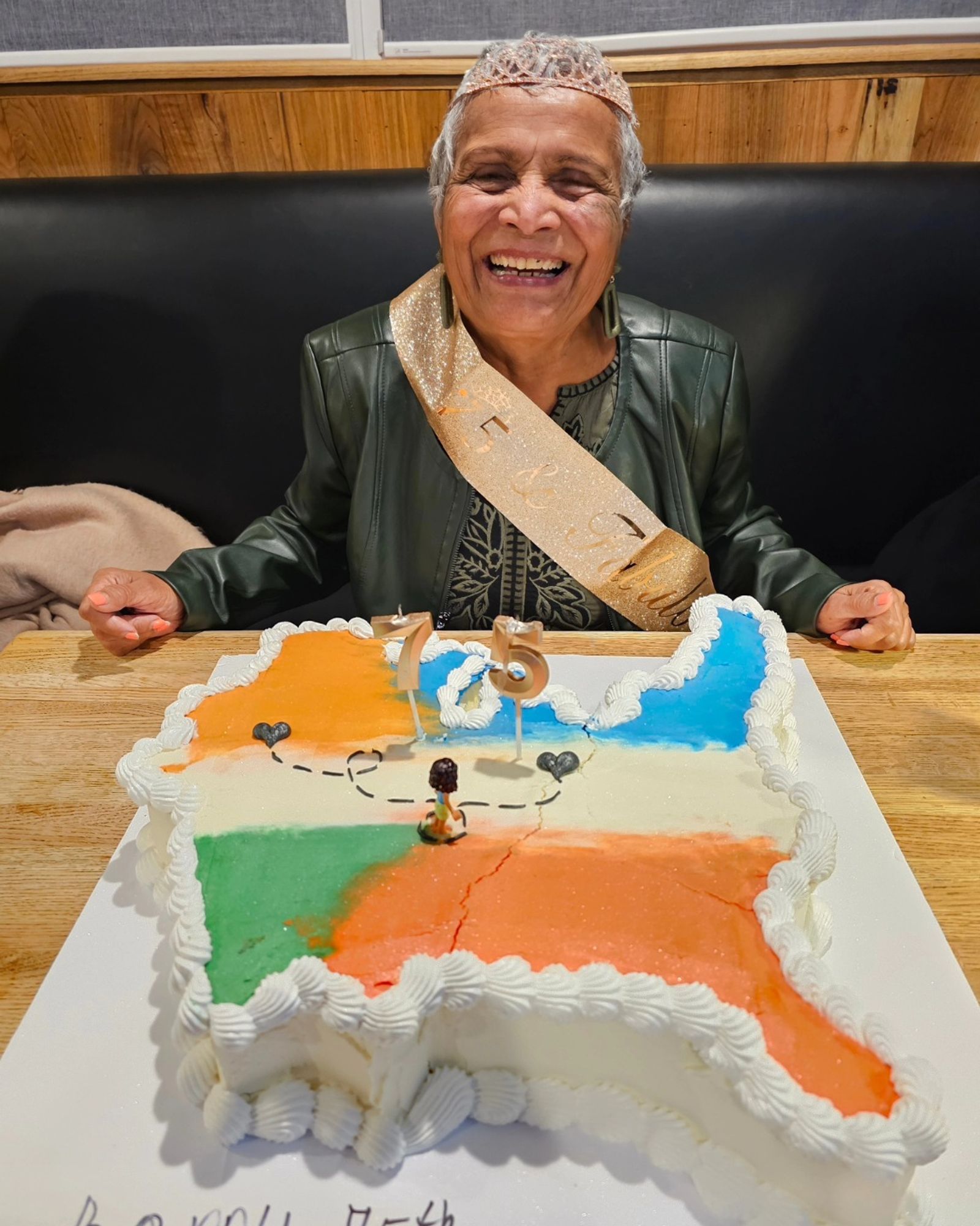 Ila Gandhi celebrating her birthday with an India-shaped cake at Porter Cullens