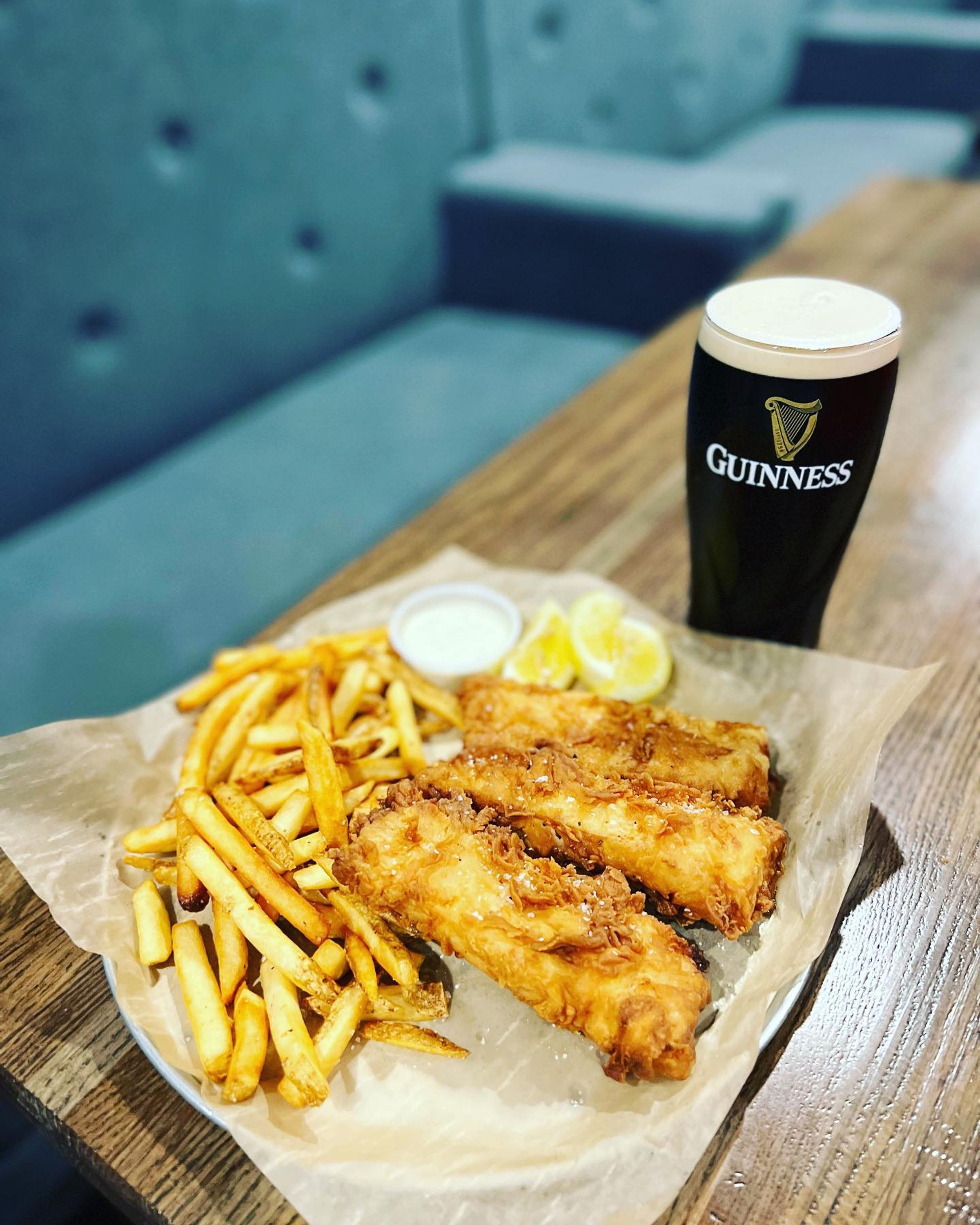 Guinness fish and chips on a board