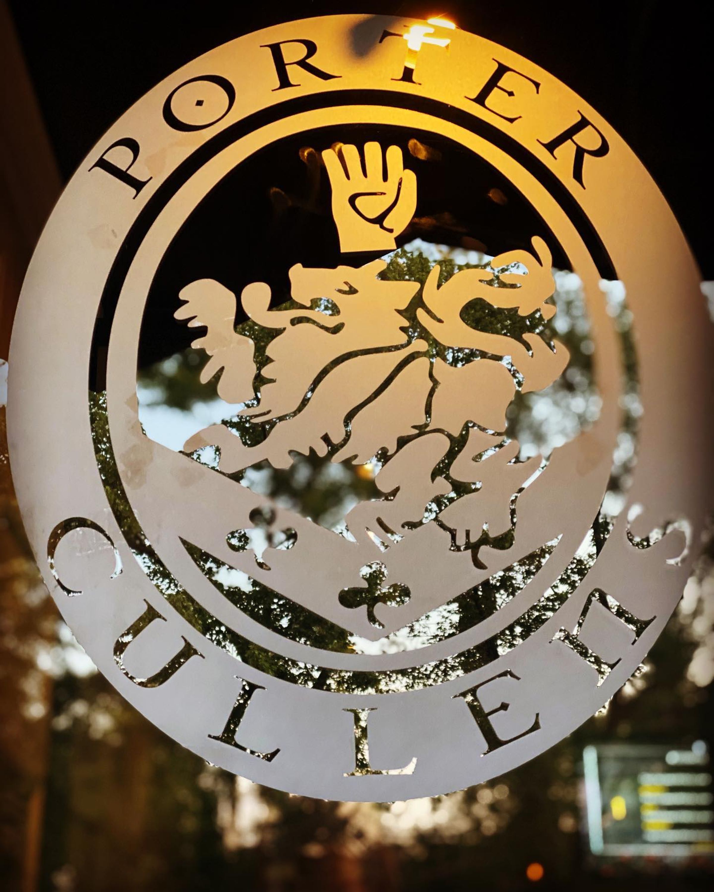 Porter Cullens crest etched in glass, glowing at night