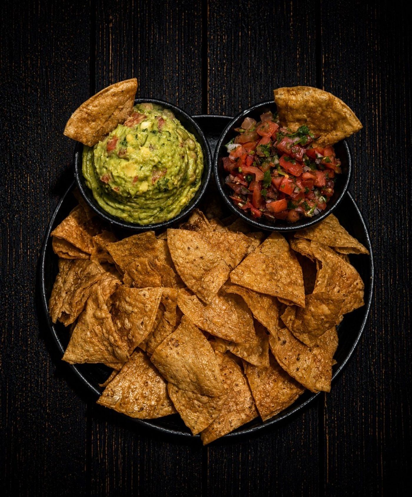 Homemade chips with guacamole and pico de gallo