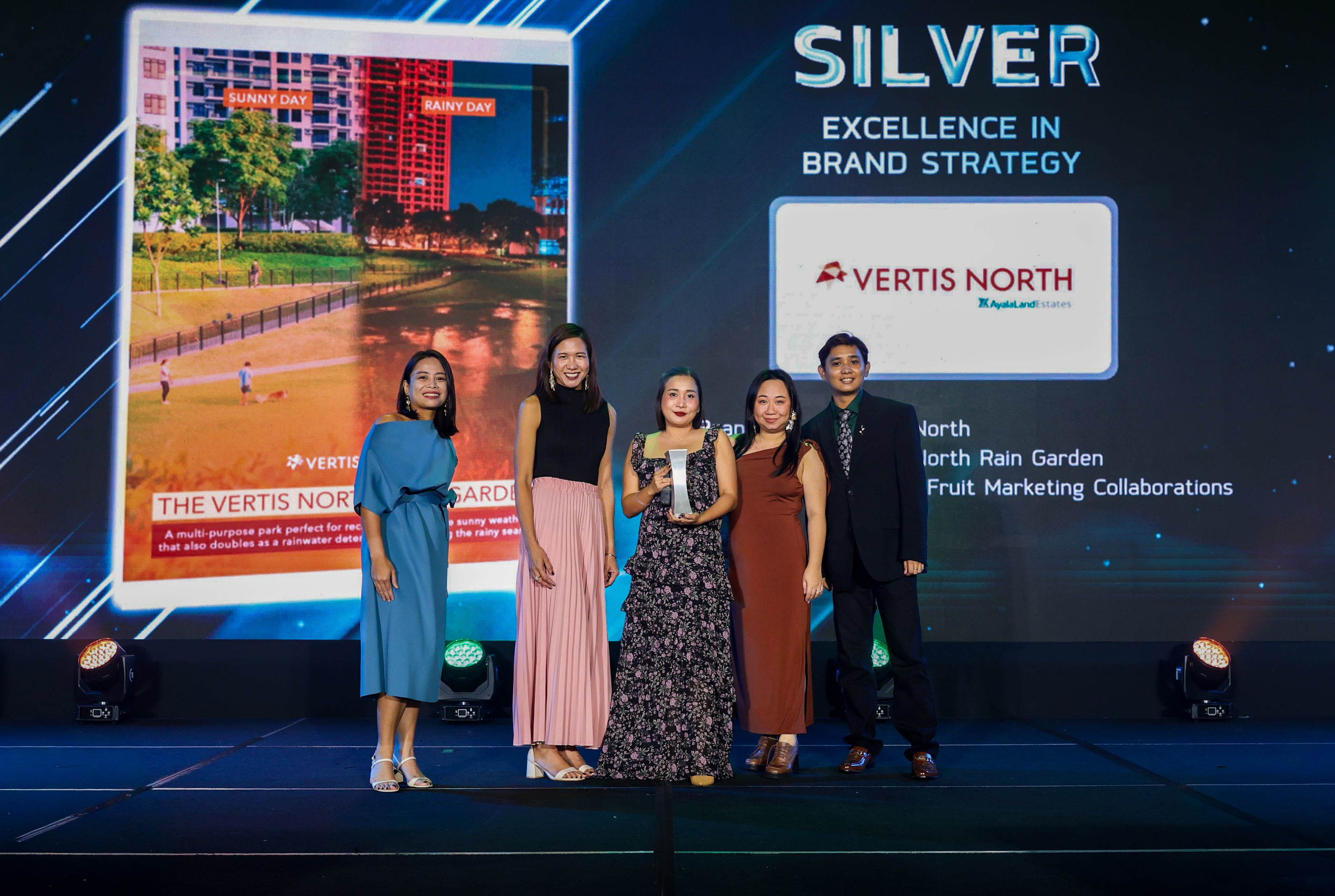 Accepting the award on behalf of Ayala Land Estates and Passion Fruit Marketing Collaborations (PFM) are Precy Abella, Accounts Director, PFM; Anne Baylon-Jara, Brand and Project Marketing Head, Ayala Land Estates; Wigiela Manlavi, Marketing Manager for Vertis North, Ayala Land Estates; Denice Lao-Manandala, Founder, PFM; and Raymund Bilo, Marketing Associate, PFM.