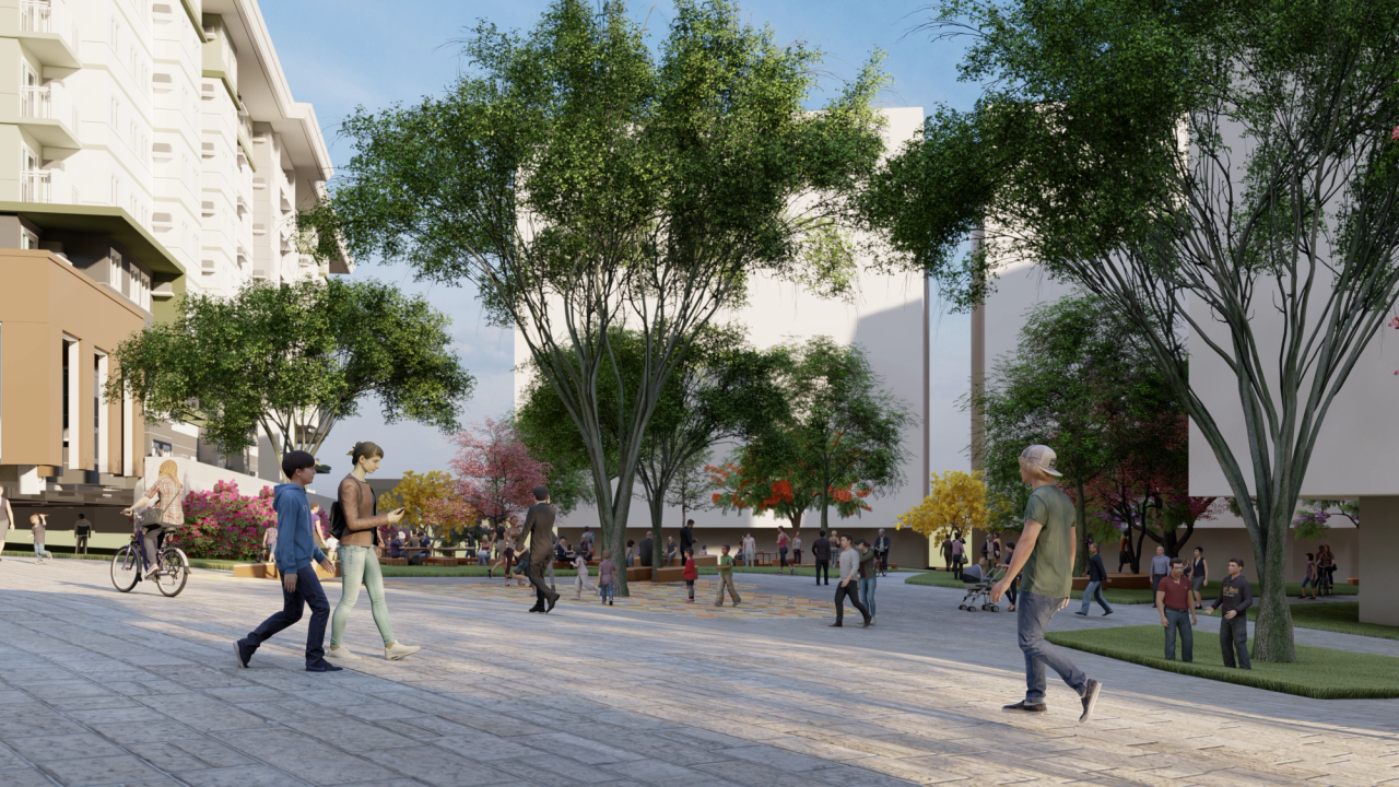 Rendered scene of a modern urban plaza with people walking, cycling, and interacting in a tree-lined open space. The area is surrounded by mid-rise buildings with clean, minimalist facades. Trees with lush green canopies and some with red or yellow leaves add color and shade. The atmosphere is relaxed and community-focused, with diverse groups enjoying the public space.