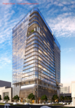 A tall, modern office building with a glass exterior stands against a partly cloudy sky. The structure features multiple floors and rounded corners, with trees and smaller buildings at street level.