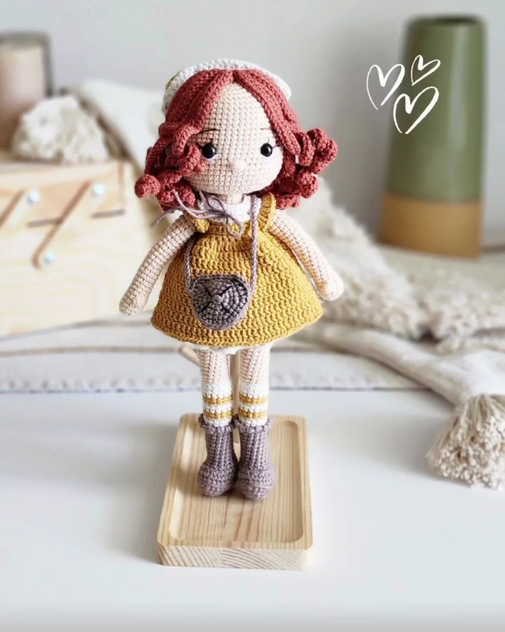 Crochet doll with curly red hair and a mustard dress