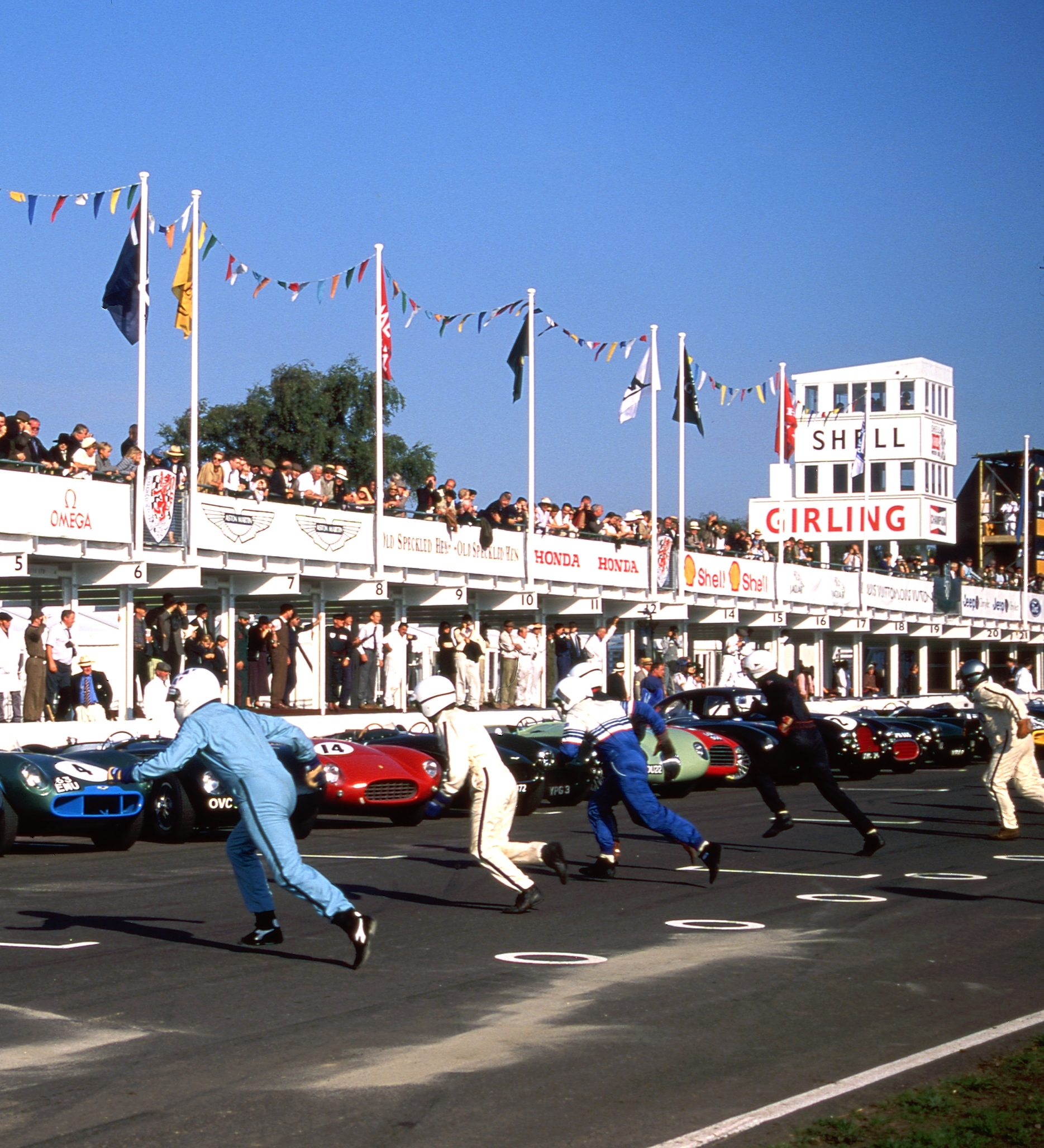 Crowd of attendees at the Goodwood Festival of Speed taking photos of the large white car sculpture.