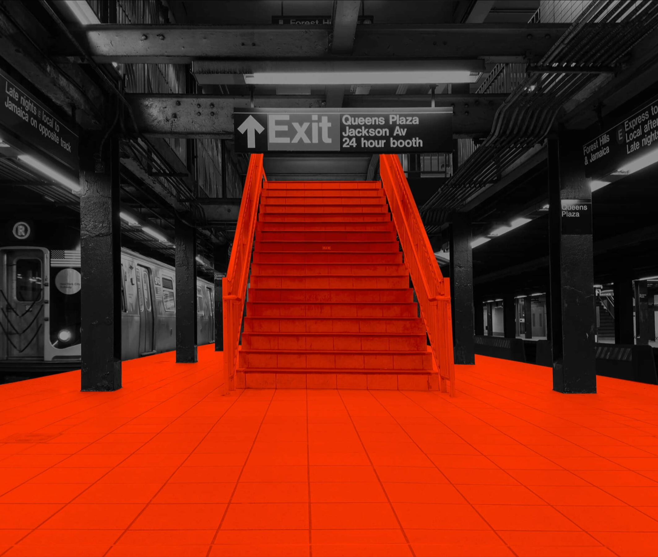 Black and white image of a subway station with orange painted over the platform and stairs.