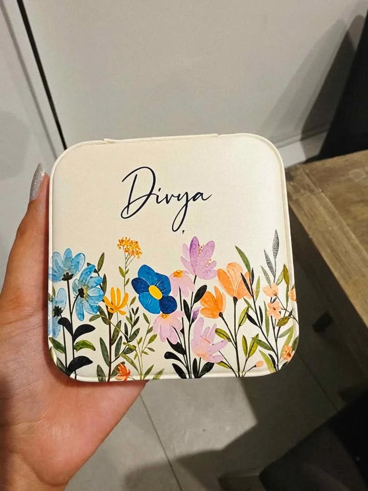 A small jewellery box printed in full colour with a floral design and a name on the lid.