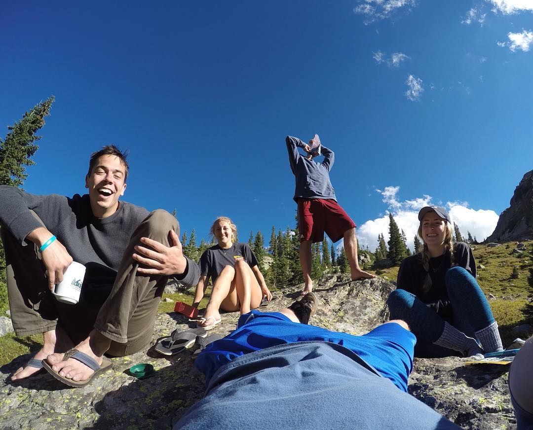 Smiling group photo on boulder in Colorado