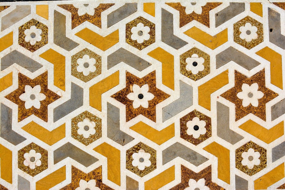 Colorful patterned tiles with interlocking yellow, gray and white shapes