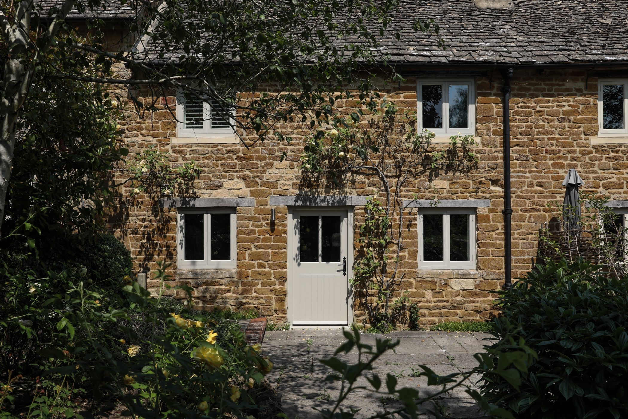 Brick cottage exterior with ivy covered walls