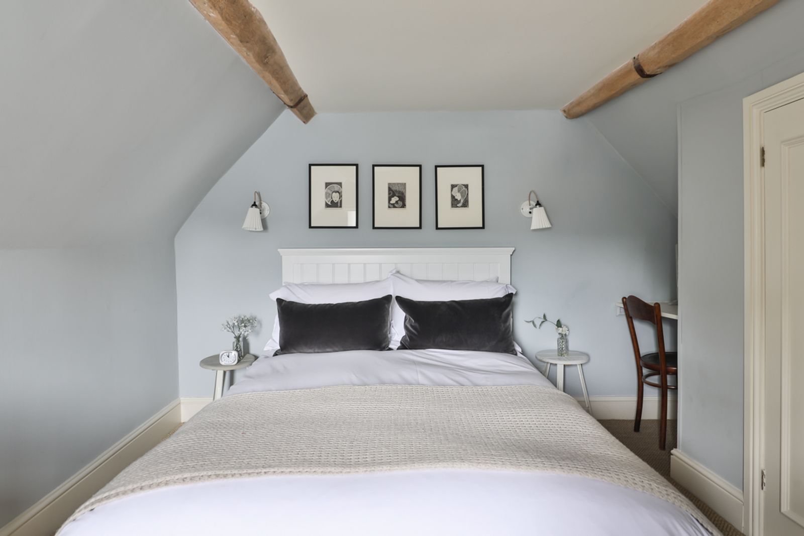 Double bedroom with wooden beams and natural light