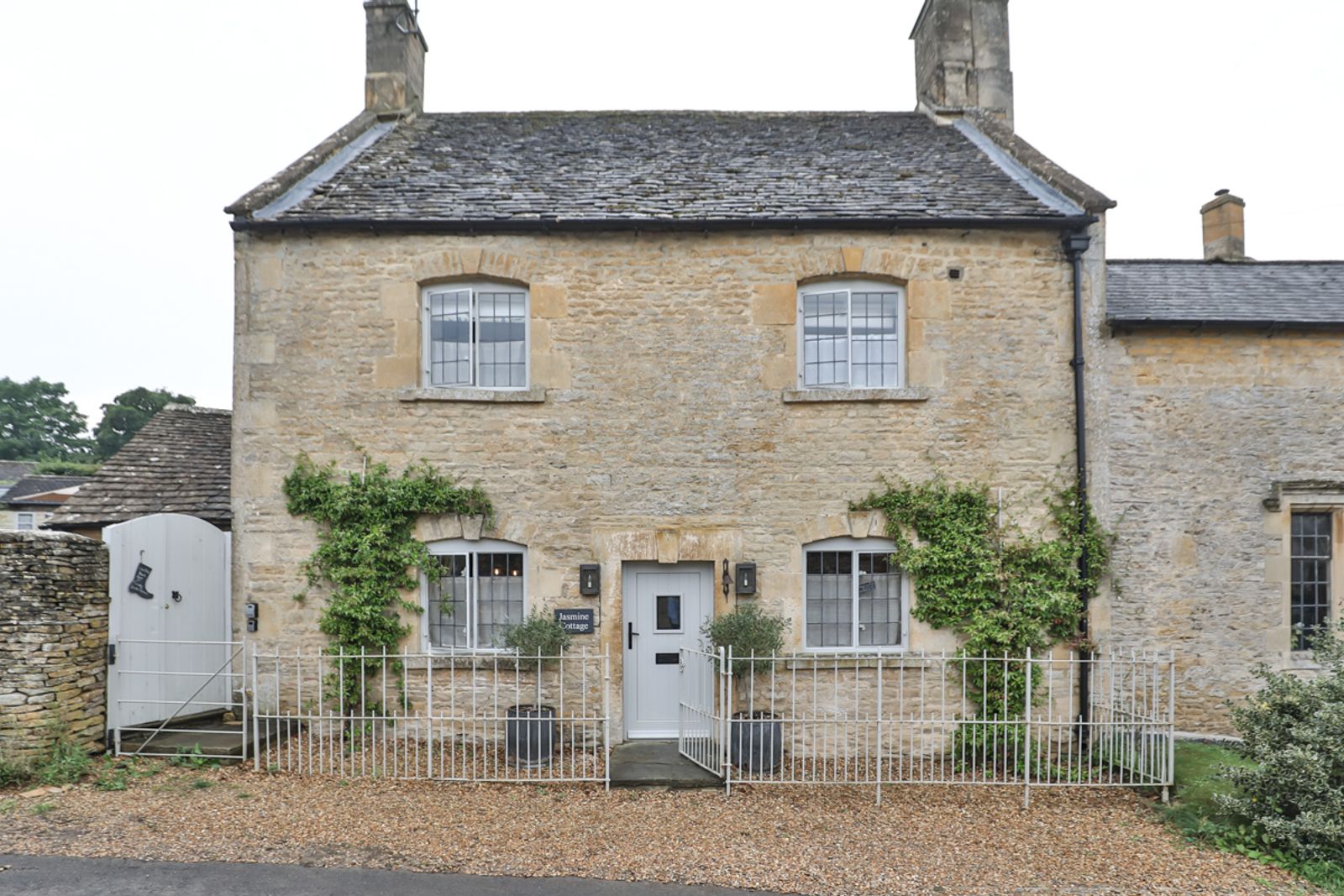 Stone cottage exterior with pale stone walls and garden