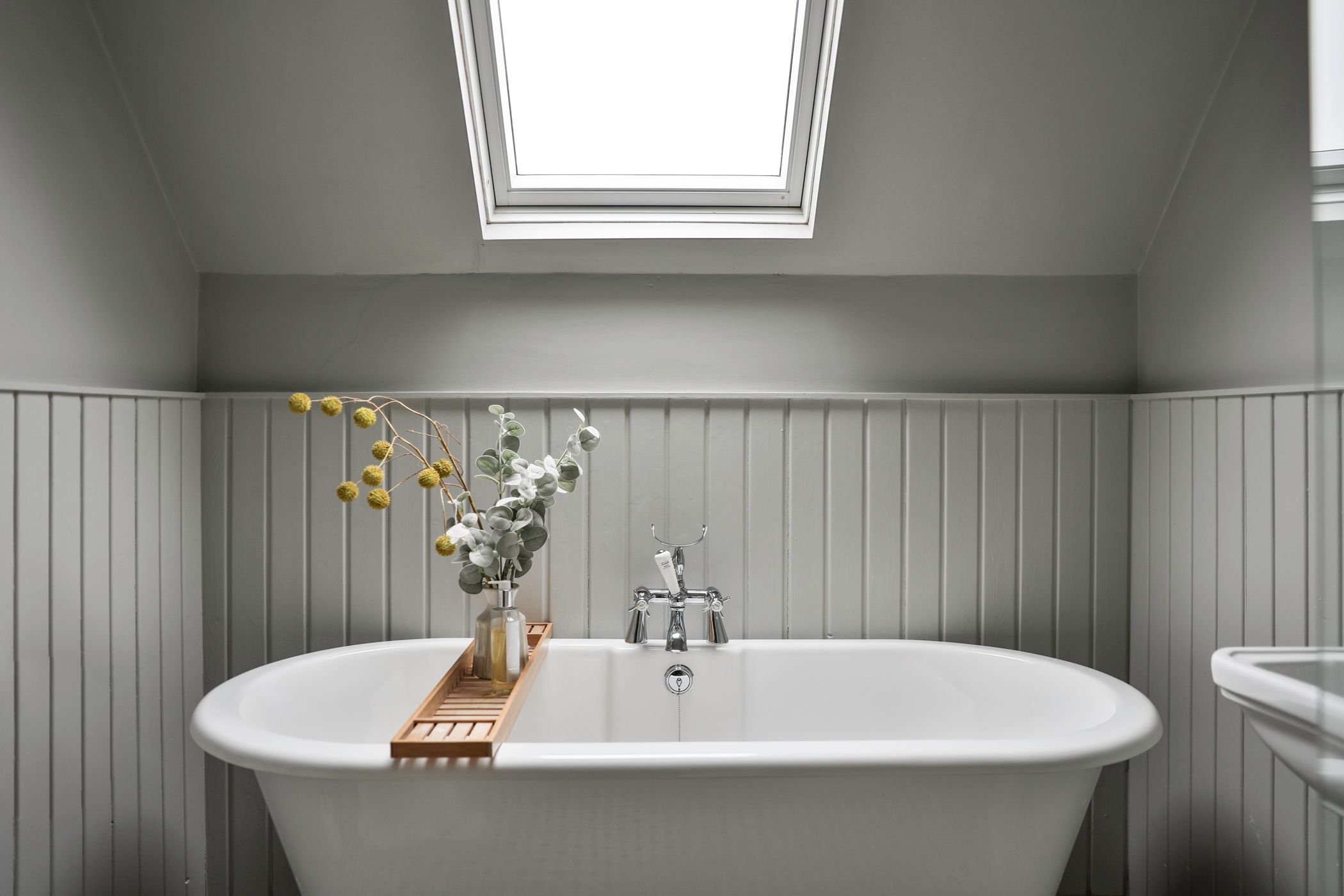 Bathroom with white freestanding tub and soft natural light
