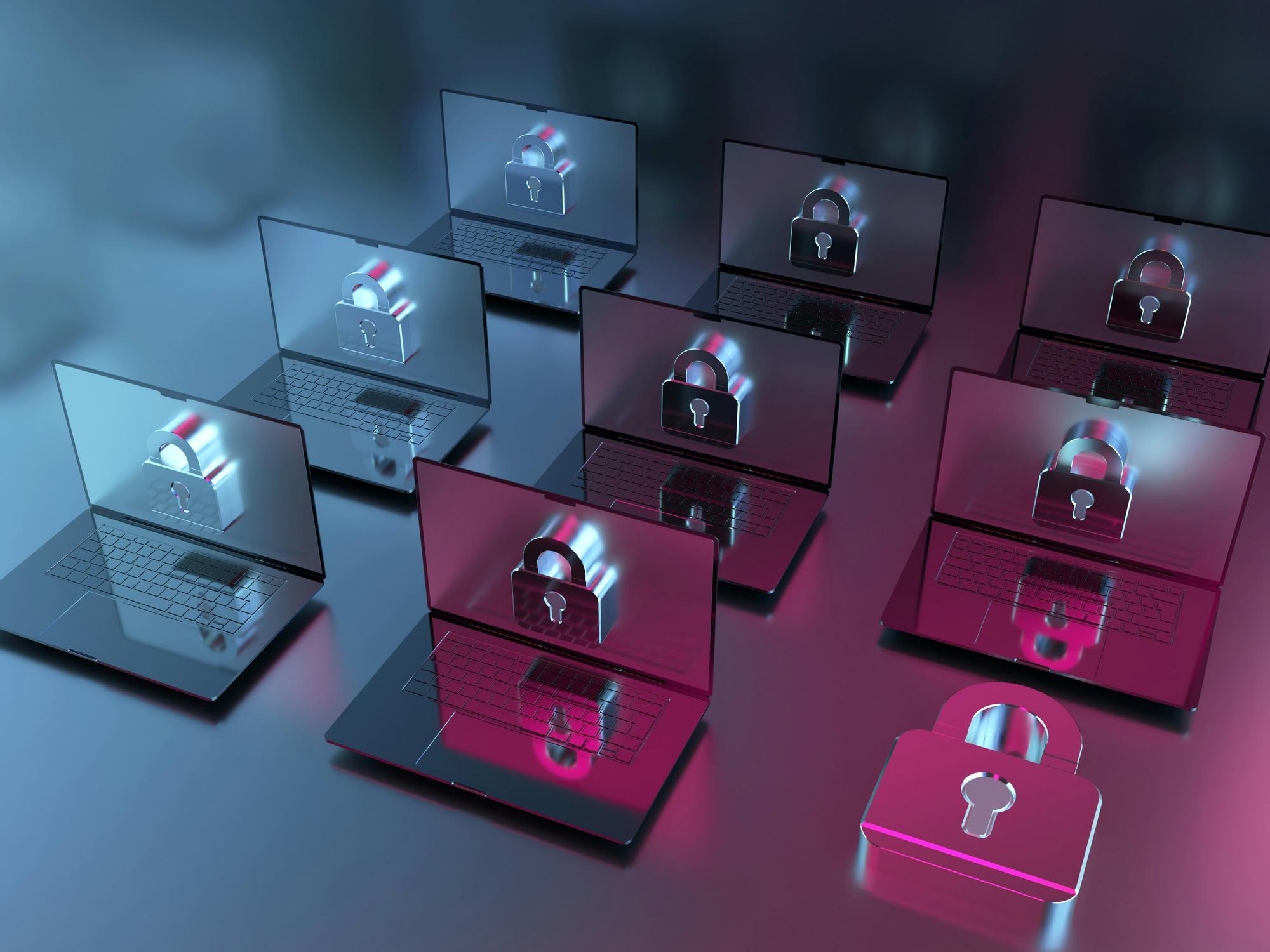 Multiple laptops with digital padlock icons on screens, symbolizing cybersecurity and data protection.