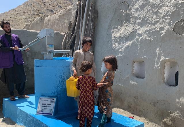 Children in Afghanistan filling water in buckets from a handpump in Afghanistan | Human Relief Mission