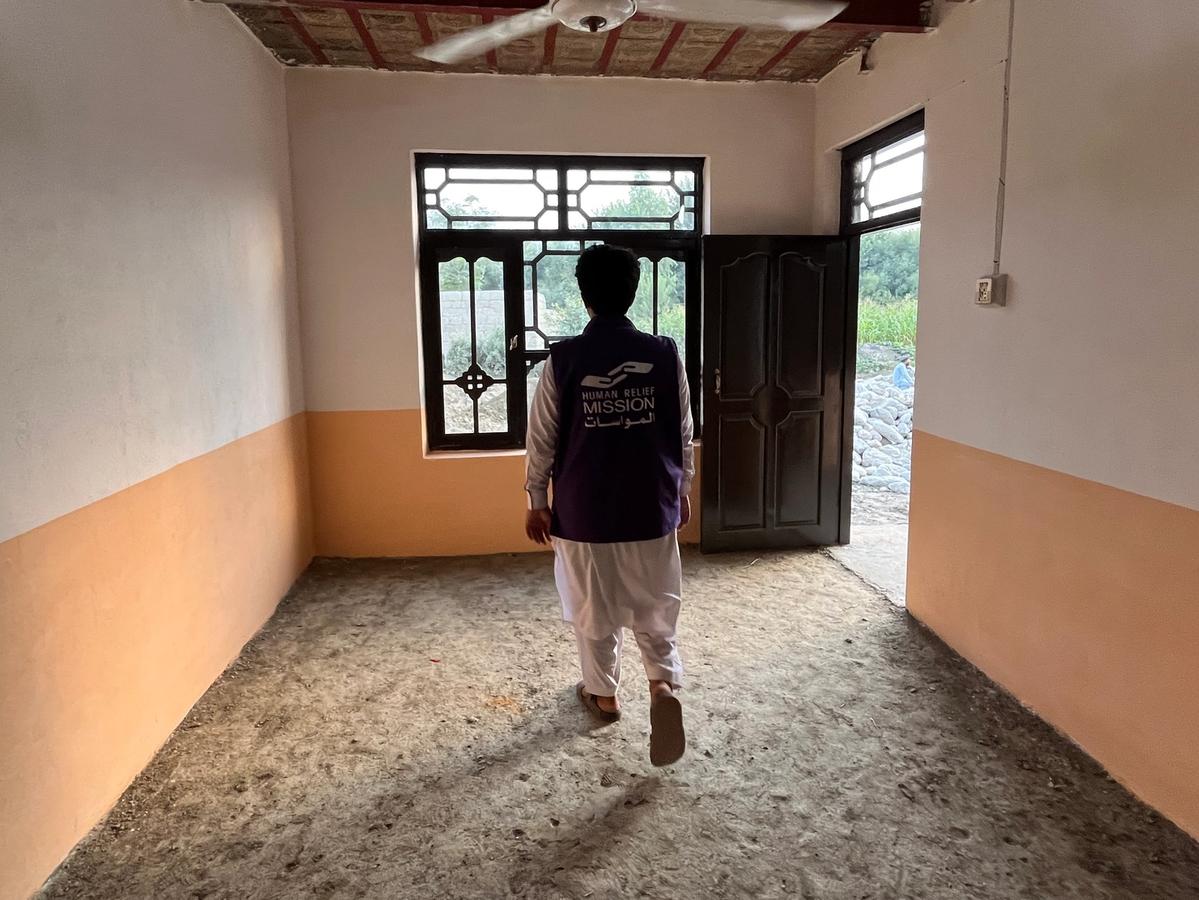 A man (HRM Aid worker) walking in a home in Afghanistan | Human Relief Mission