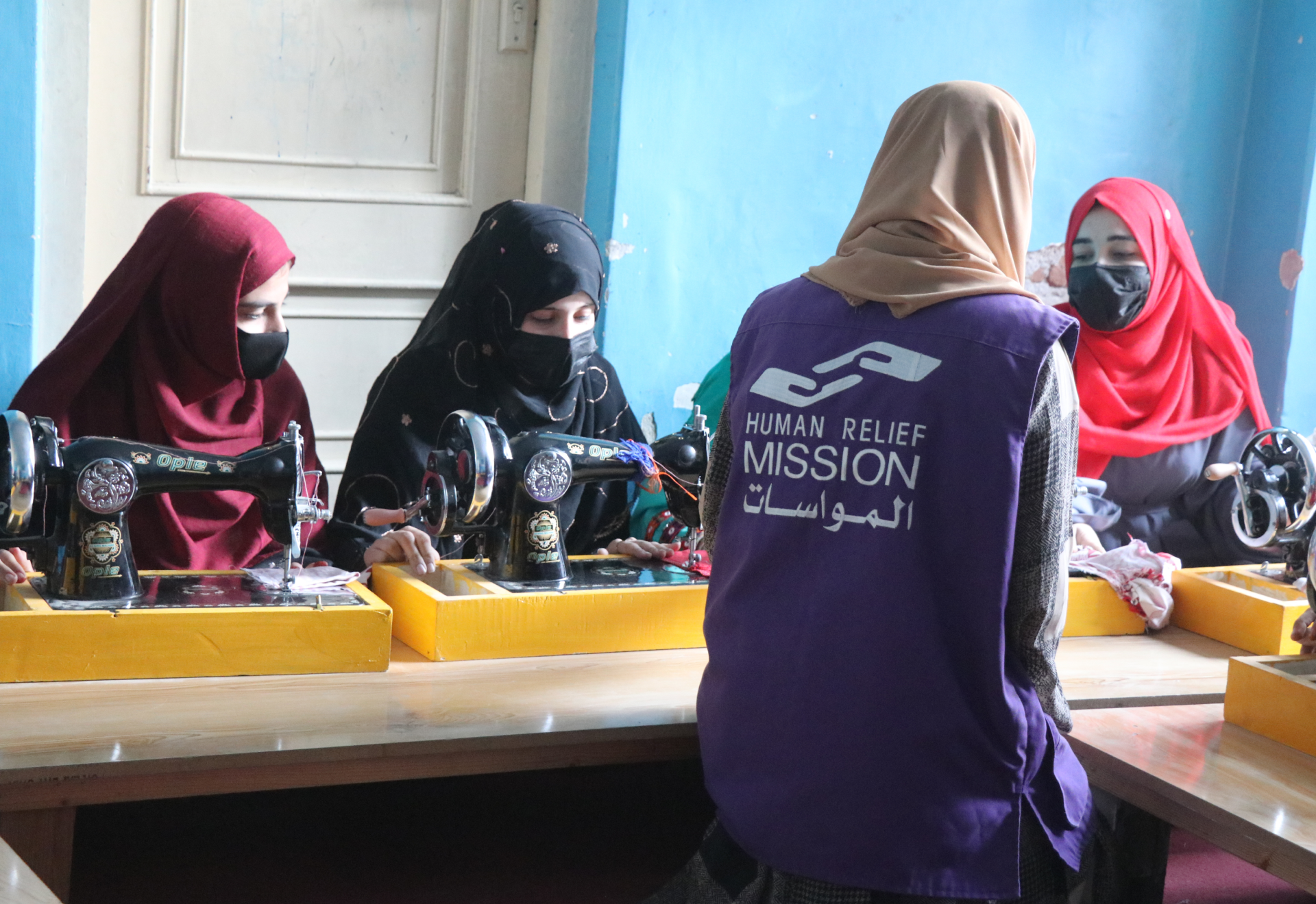 Women in Afghanistan with Sewing Machine with HRM Charity aid Worker | Human Relief Mission
