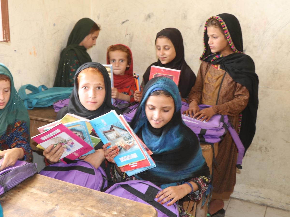 Students in Afghanistan school receiving bags with stationary and books | Human Relief Mission