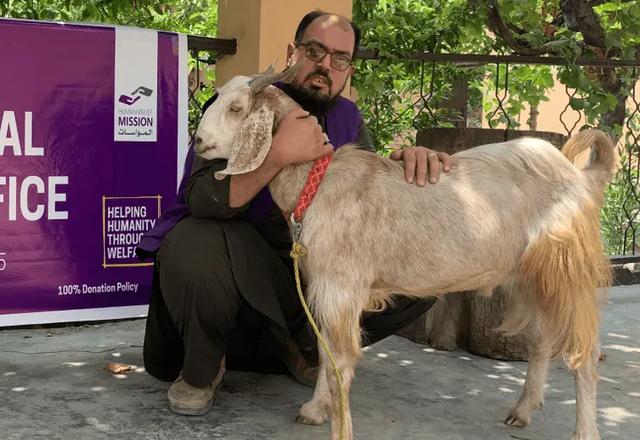 HRM Aid Worker with a Goat | Human Relief Mission