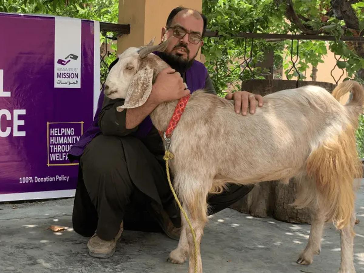 HRM Aid Worker with a Goat | Human Relief Mission