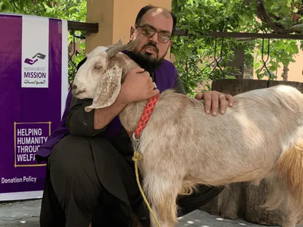 HRM Charity Aid Worker with a Goat in Afghanistan | Human Relief Mission