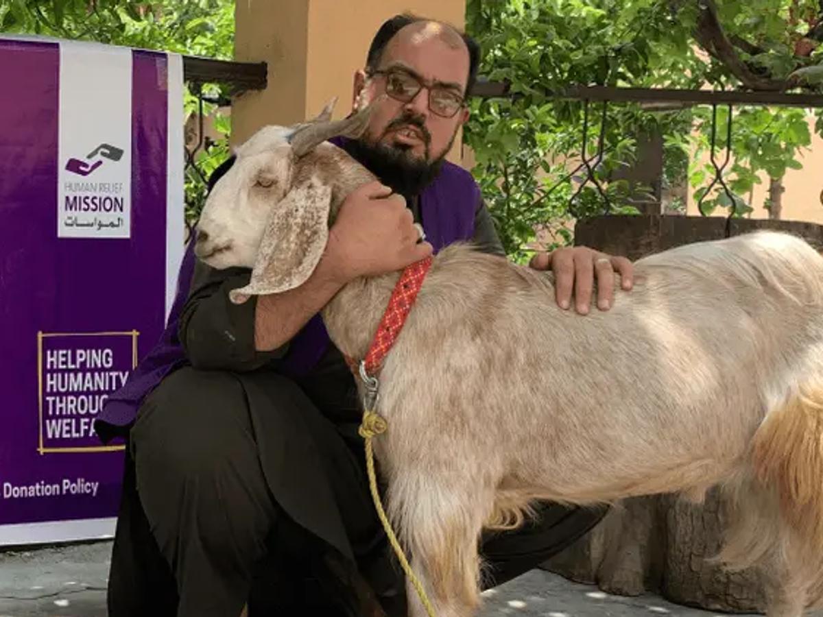 HRM Charity Aid Worker with a Goat in Afghanistan | Human Relief Mission