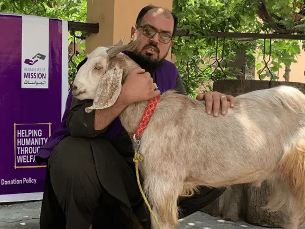 HRM Charity Aid Worker with a Goat in Afghanistan | Human Relief Mission