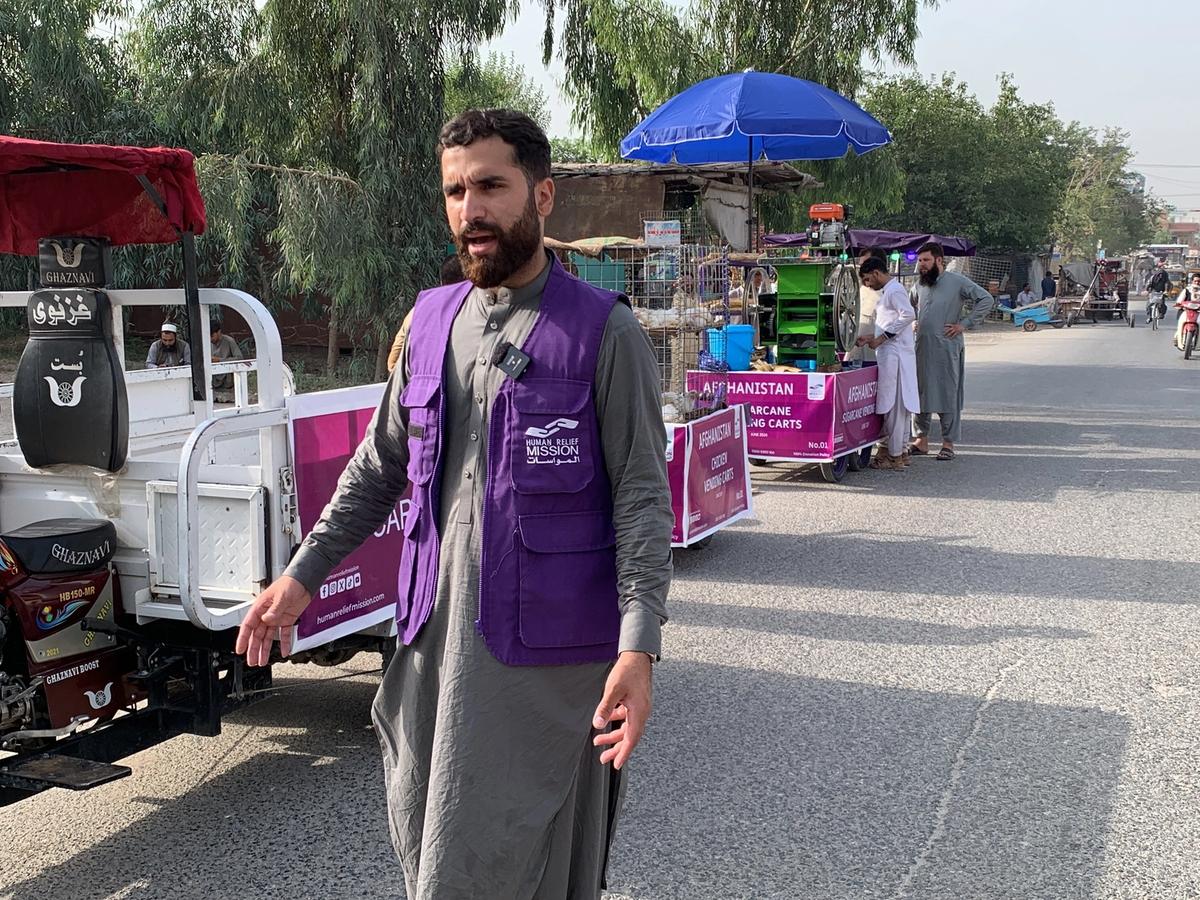 HRM Aid Worker Next to Cargo Tricycle in Afghanistan | Human Relief Mission