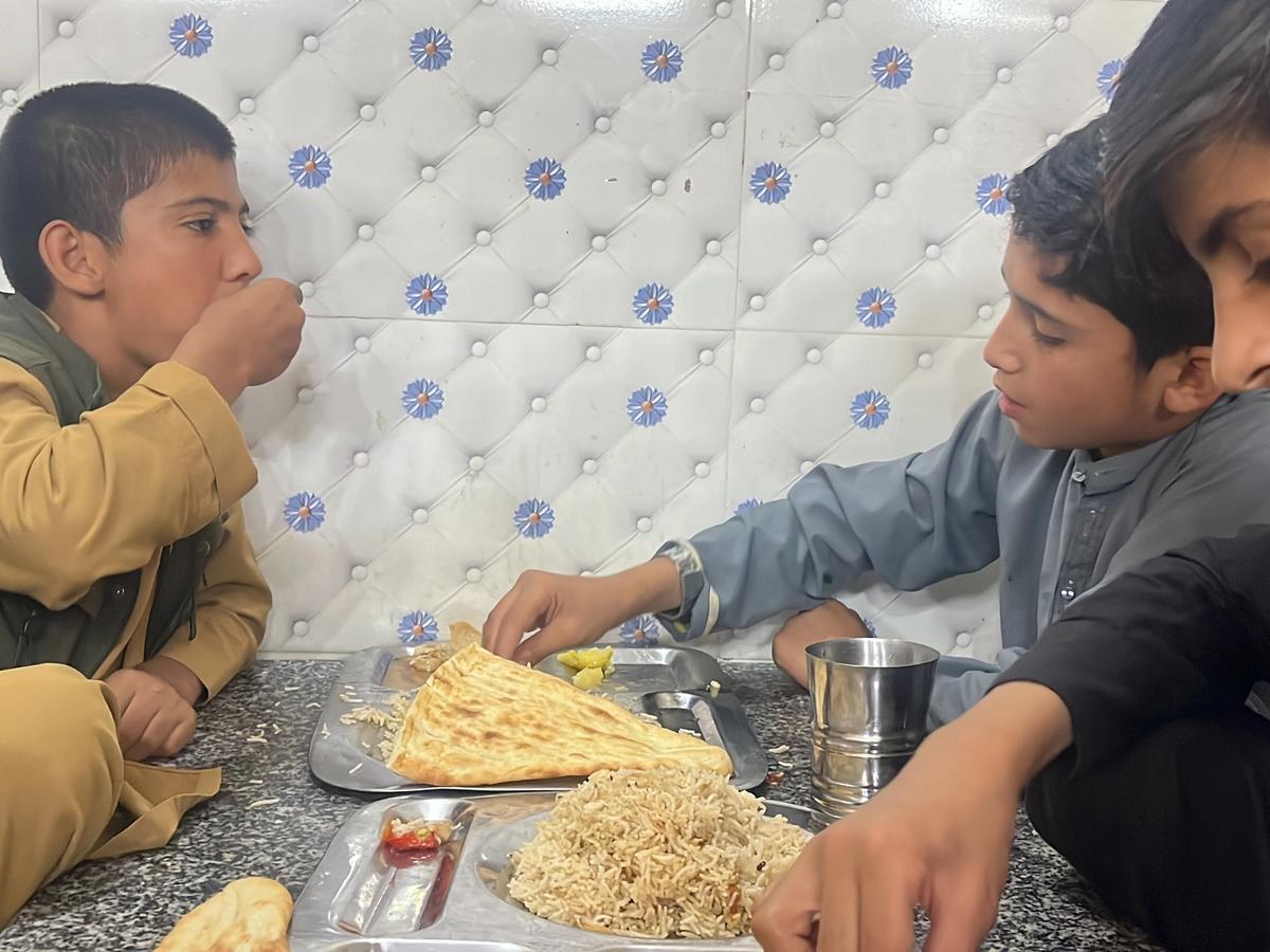 Children in Afghanistan eating a hot  meal in Afghanistan | Human Relief Mission