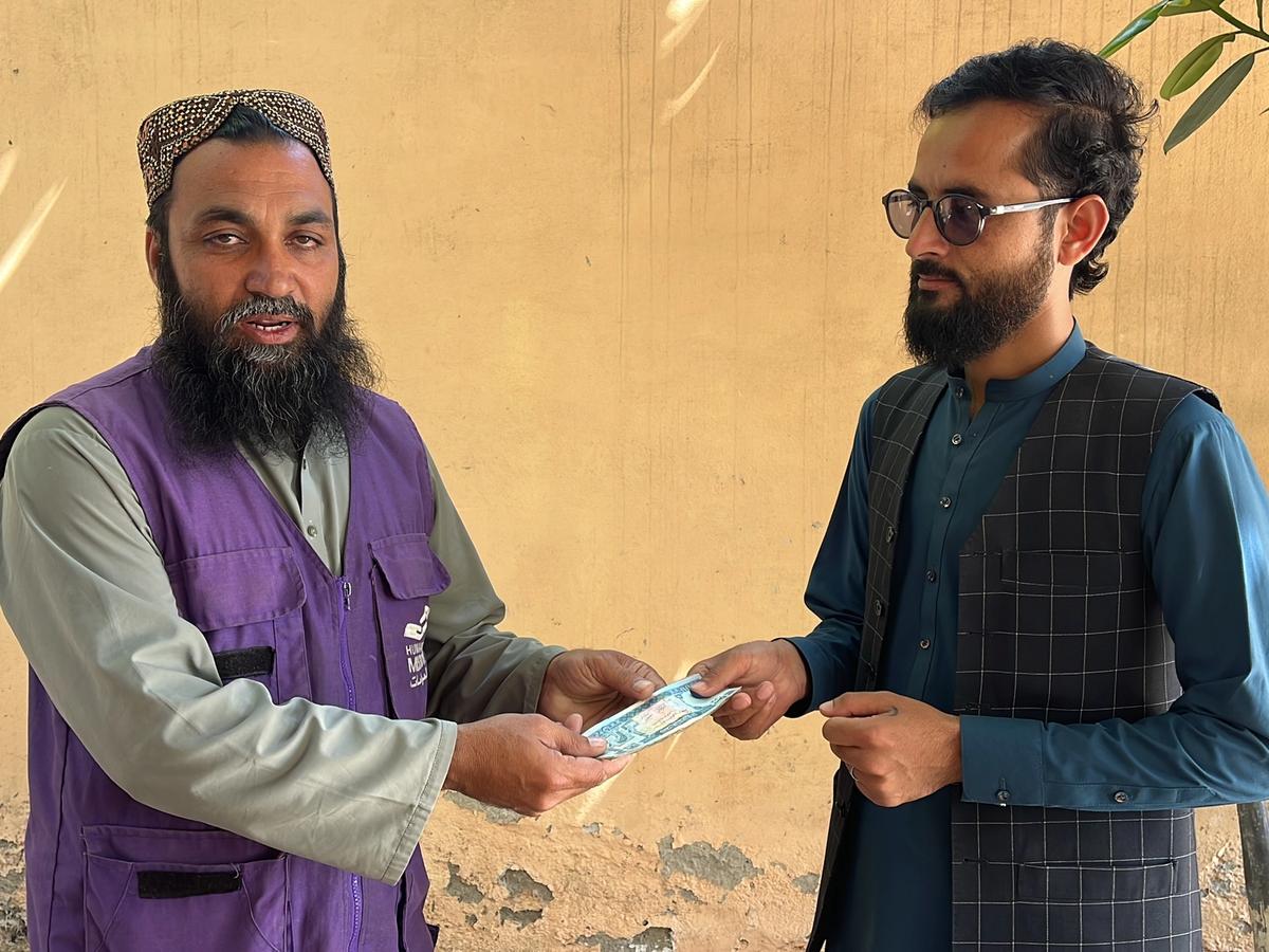 A Man in Afghanistan Receiving Cash | Human Relief Mission