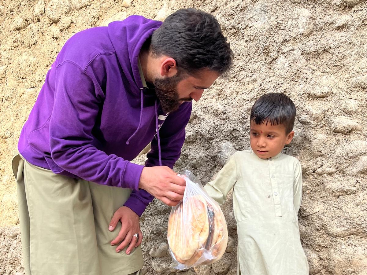 HRM Aid Worker Providing bread to a child in Afghanistan | Human Relief Mission