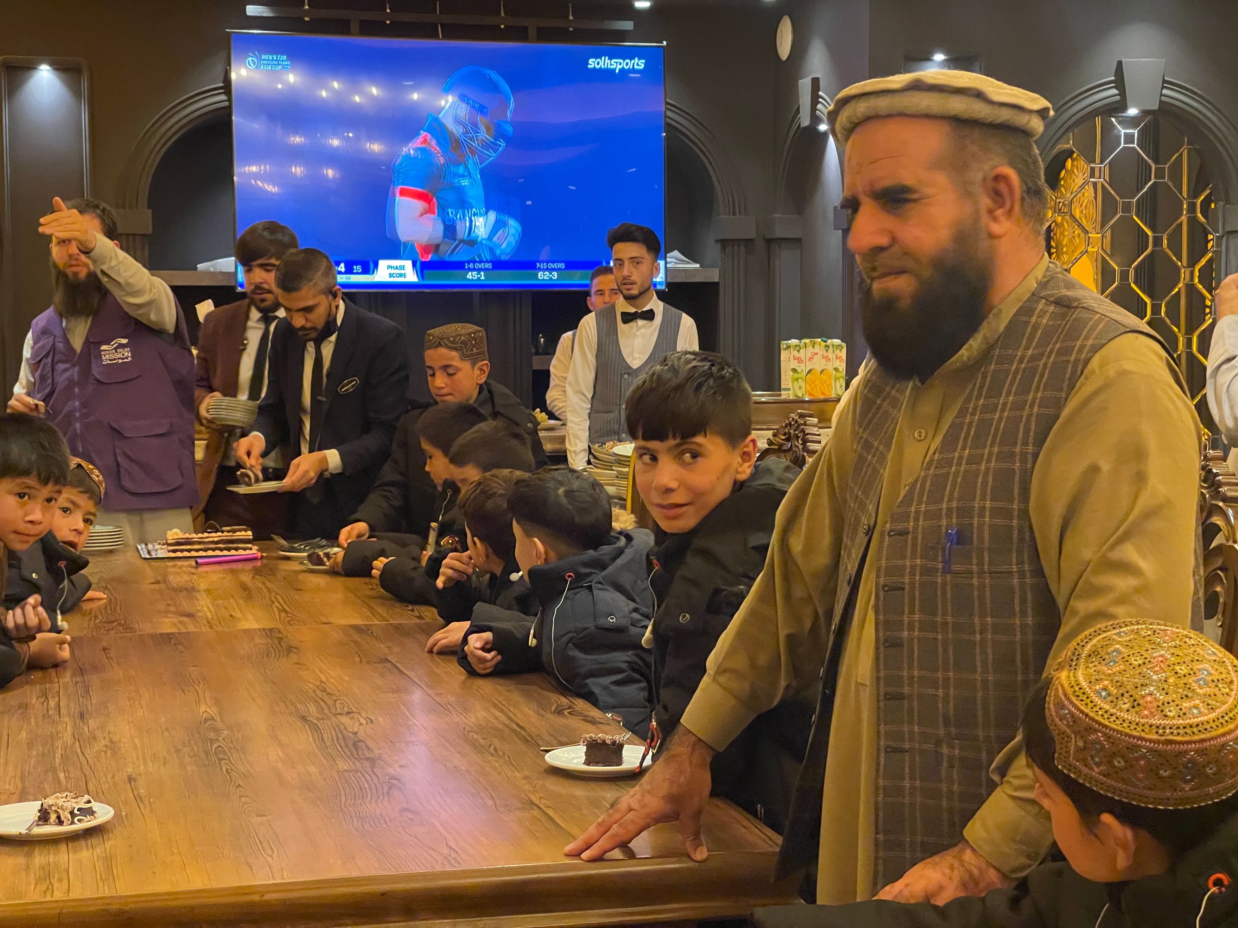 Orphans in Afghanistan Eating with HRM Aid Worker | Human Relief Mission