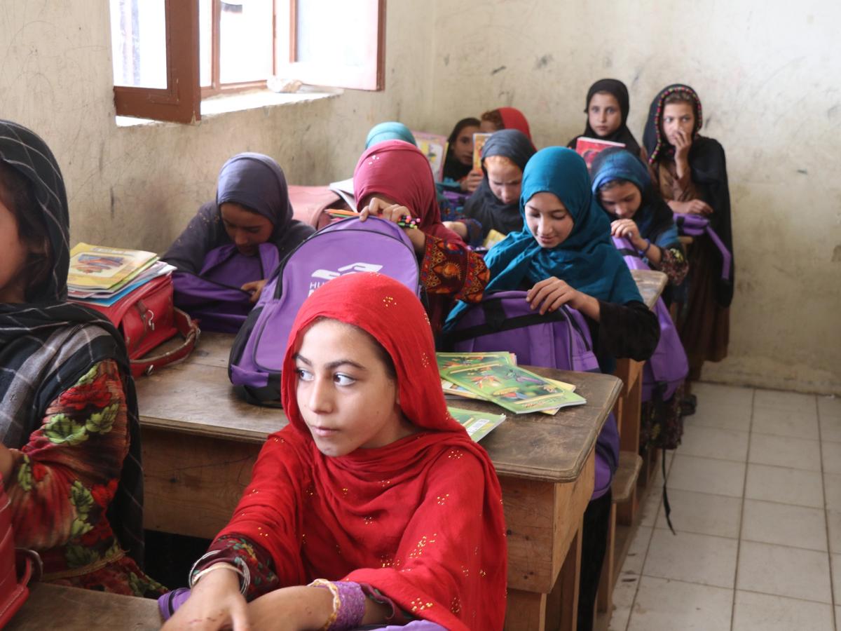 Students in Afghanistan school receiving bags with stationary and books | Human Relief Mission