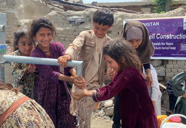 Children in Afghanistan enjoying water from water well | Human Relief Mission